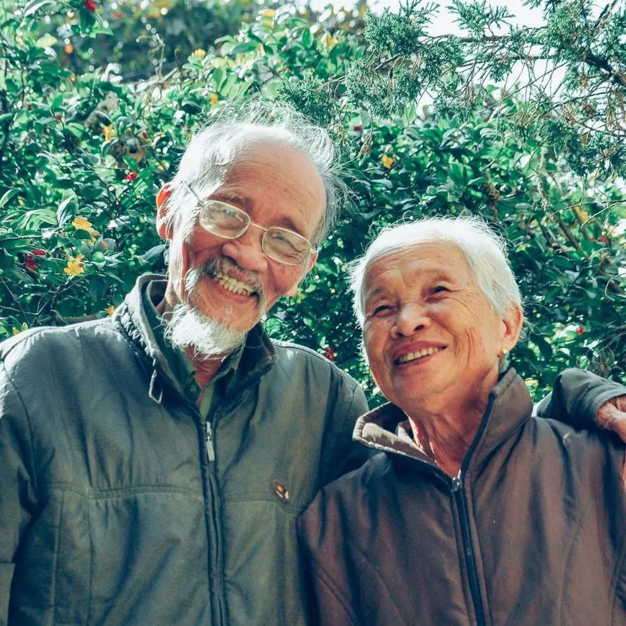 An older couple smiling together outdoors