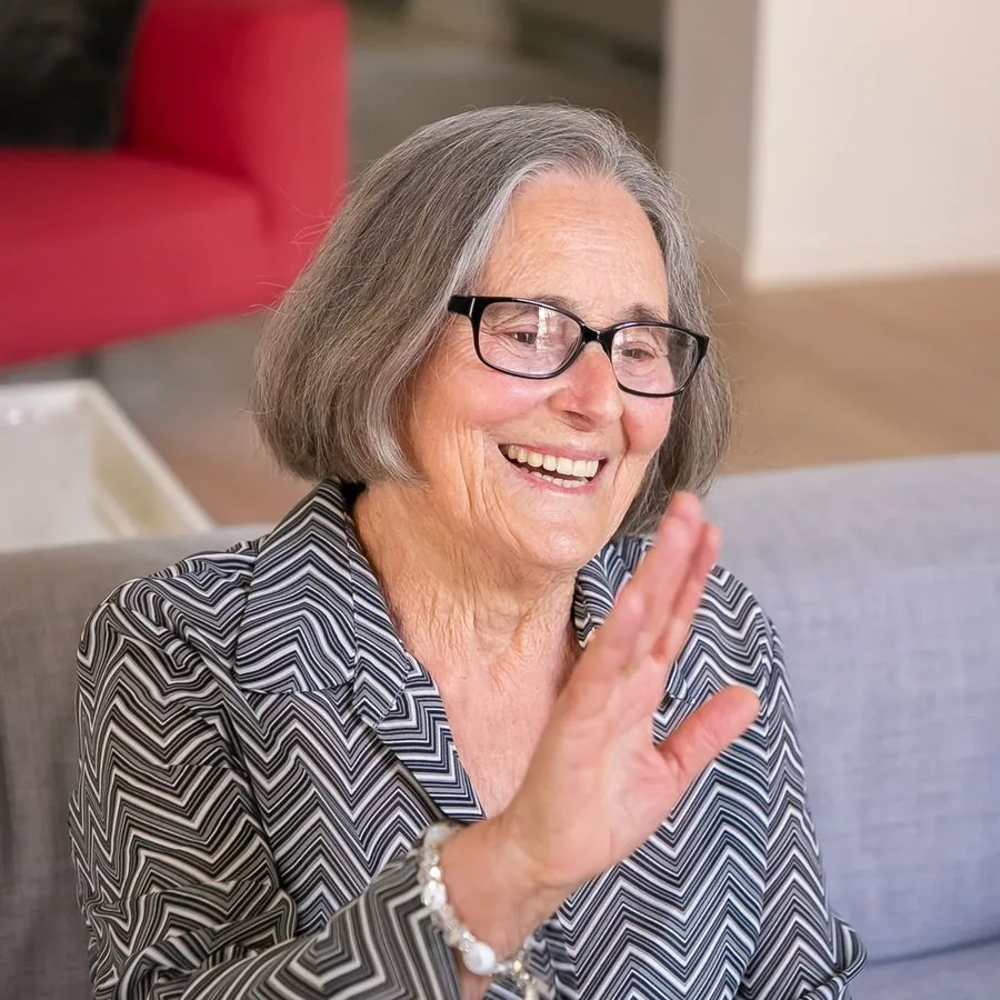 A woman relaxing at home, waving hello