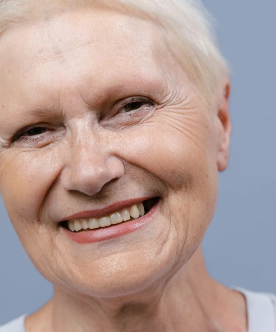 A close-up of a smiling woman with clear, bright eyes