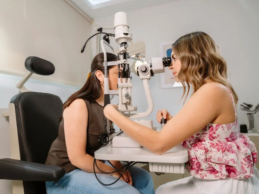 A patient at the slit lamp during an eye exam
